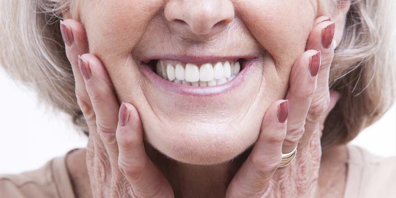Woman confident smile wearing dentures